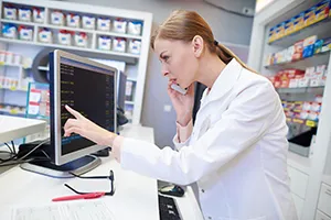 Scientists collaborating on pharmacovigilance using advanced technology