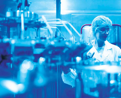 A futuristic laboratory scene illustrating sustainable green pharmaceutical manufacturing with eco-friendly materials and renewable energy sources.