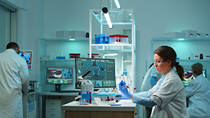 Lab technicians equipment and data charts for drug development