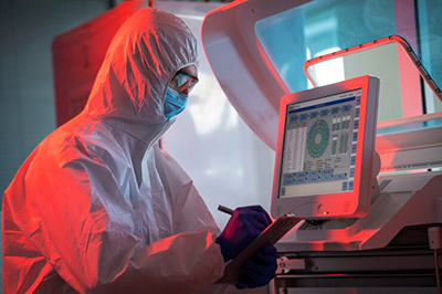 Technician checking data from real-time microbial detection system