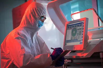 Technician checking data from real-time microbial detection system