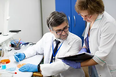 Researchers discussing process design strategies for peptide production.