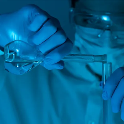 Forensic scientist preparing samples for chromatography drug testing in a laboratory setting